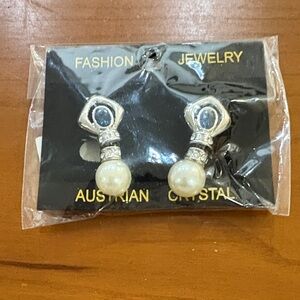 Elegant Silver and Pearl Earrings. Has white small stones and a big blue stone